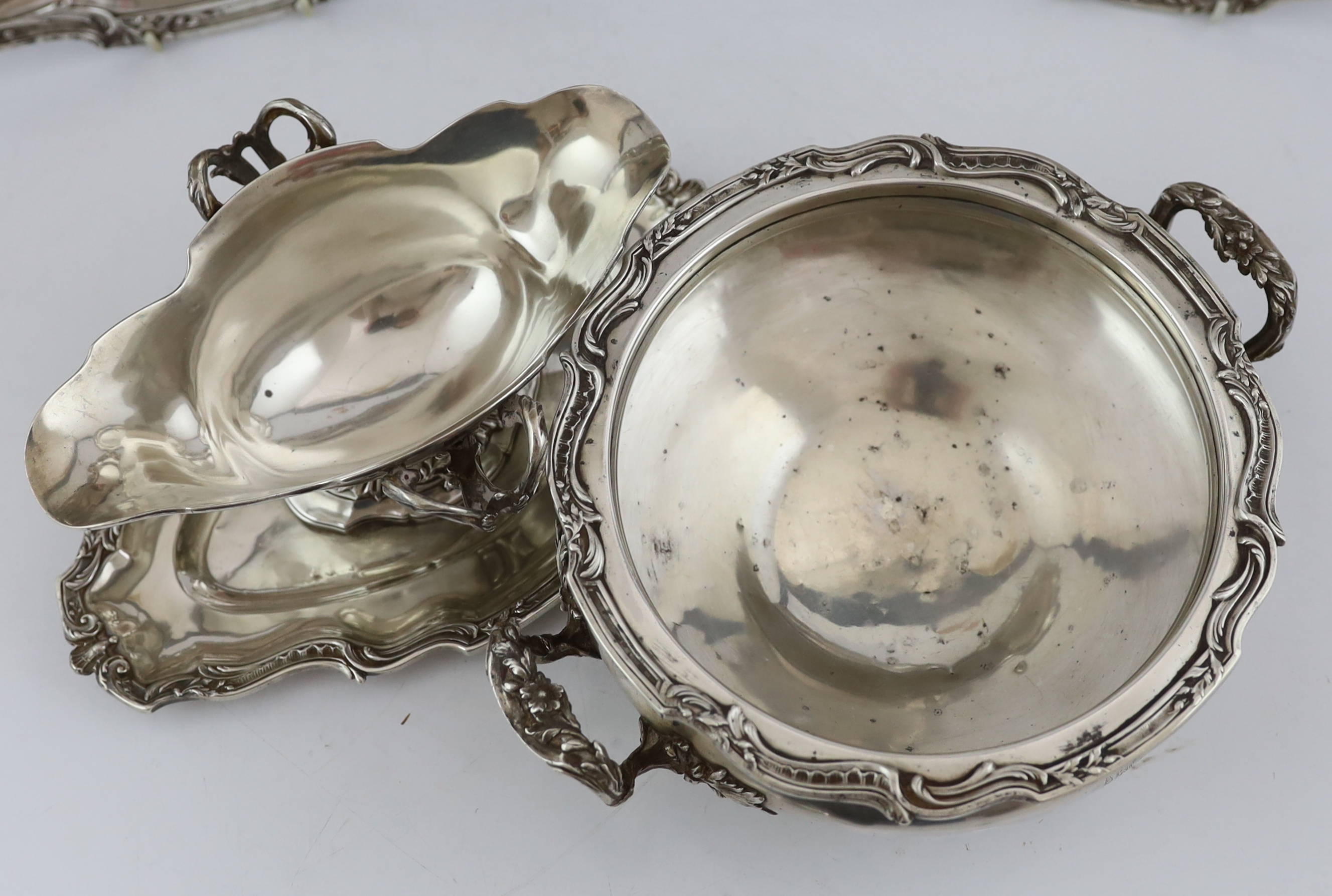 A late 19th century French 950 standard silver tureen and cover, a sauceboat on fixed stand and two serving dishes, by V. Boivin, Paris